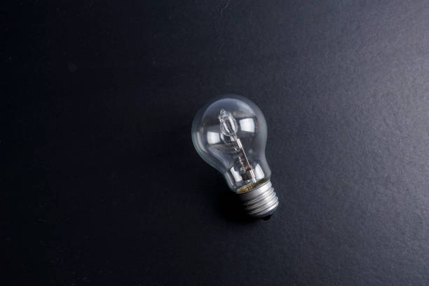 istock Idea concept word IDEA. Light of bulb on grey background. Low light 1200098649