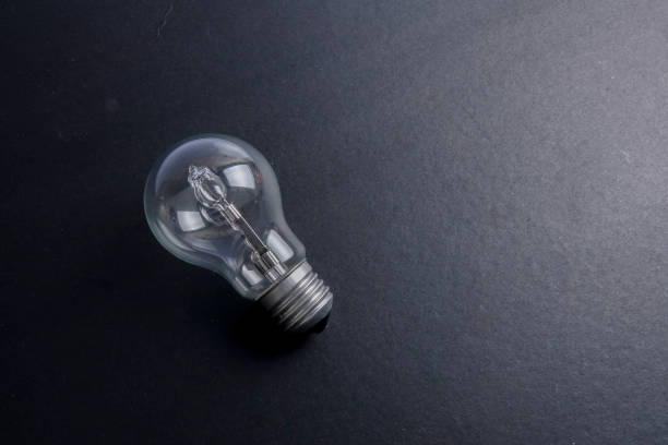 istock Idea concept word IDEA. Light of bulb on grey background. Low light 1200098657