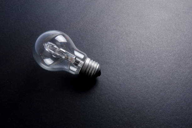 istock Idea concept word IDEA. Light of bulb on grey background. Low light 1200098672
