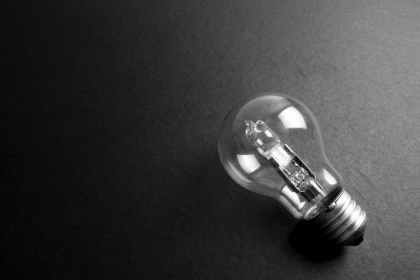 istock Idea concept word IDEA. Light of bulb on grey background. Low light 1200098704