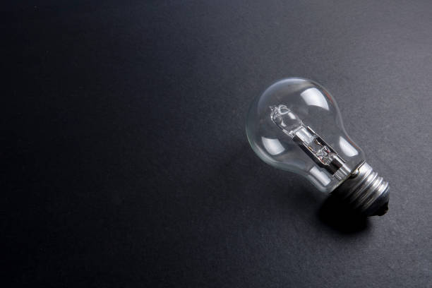 istock Idea concept word IDEA. Light of bulb on grey background. Low light 1200098725