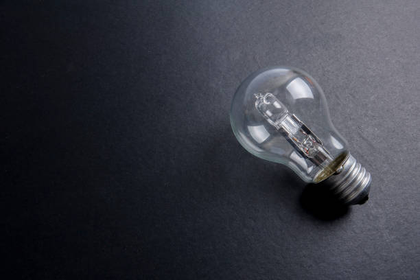 istock Idea concept word IDEA. Light of bulb on grey background. Low light 1200098756