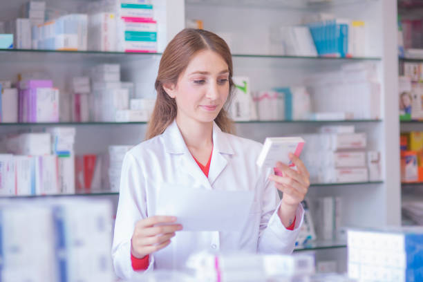 istock pharmacist looking at prescription drugs 1200099331