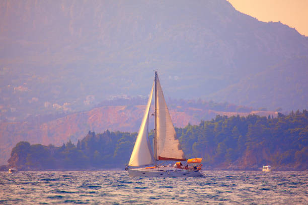 istock Yacht sailing along the shore 1200100063