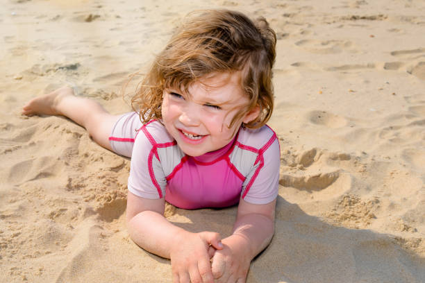 istock cute little girl on the sunny beach 1200102911