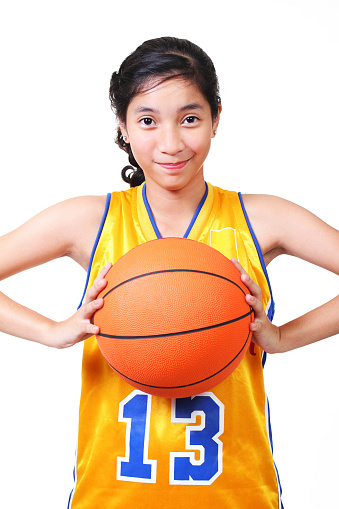 young asian lady basketball player.white background.high key