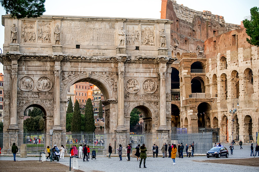 Rome, Italy, January 15 -- A view of the famous Arch of Constantine, near the Colosseum. The largest triumphal arch of the ancient world celebrates the victory of Emperor Constantine over Maxentius in 312 AD. in the battle of Ponte Milvio. The international tourist guide TripAdvisor has proclaimed the Colosseum as the most visited monument in the world in 2019, according to data collected from the reservations of visitors and tourists, surpassing famous tourist destinations such as the Louvre Museum in Paris and the Vatican Museums. Image in HD format.