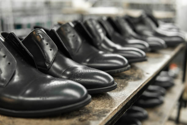 A lot of new black shiny shoes on a shelf. Shoe factory, finished goods warehouse. stock photo