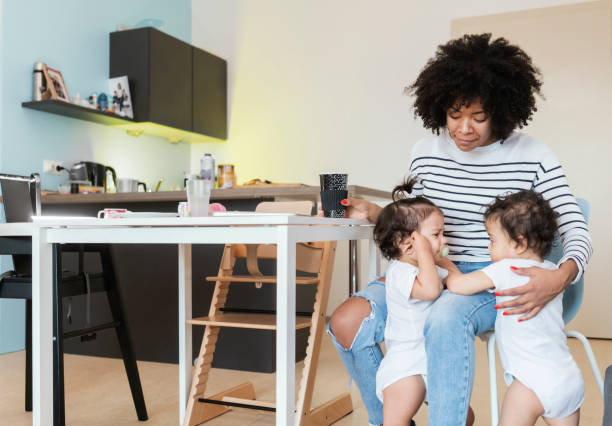 istock Mom and babies at home 1200104683