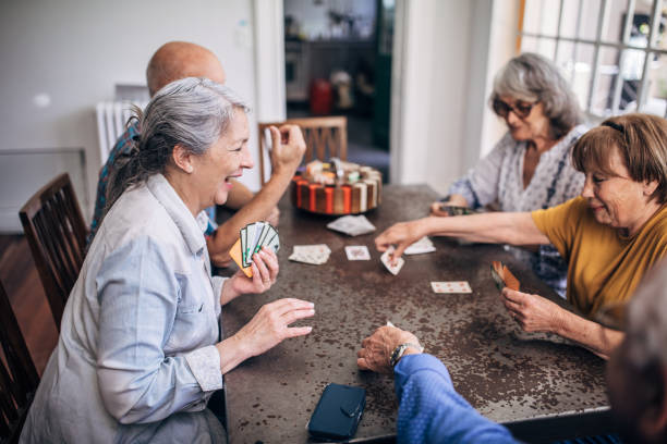 istock Old friends having fun playing cards 1200104812