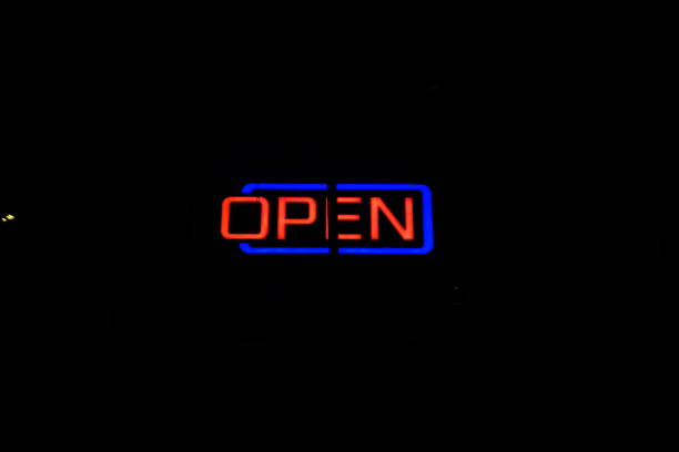 istock Open neon sign in red and blue at night on black background 1200106000