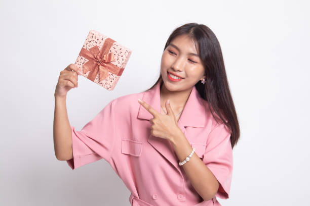 istock Young Asian woman with a gift box. 1200106439