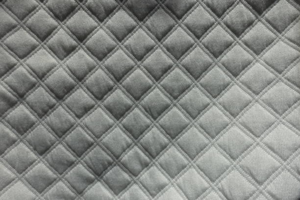 istock Top view of white quilted fabric with diamond pattern 1200109132