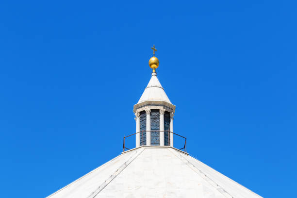 istock Tower of a church with a golden cross 1200109727