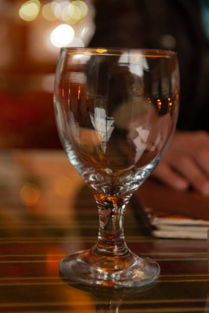 istock wine glass in ambient environment beautiful reflections and bokeh 1200110456