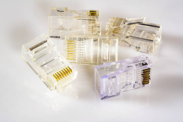 istock Connector rj-45. Five transparent connectors rj45 for cable for network and internet. Close-up macro on gloss white background with shadow. 1200110670