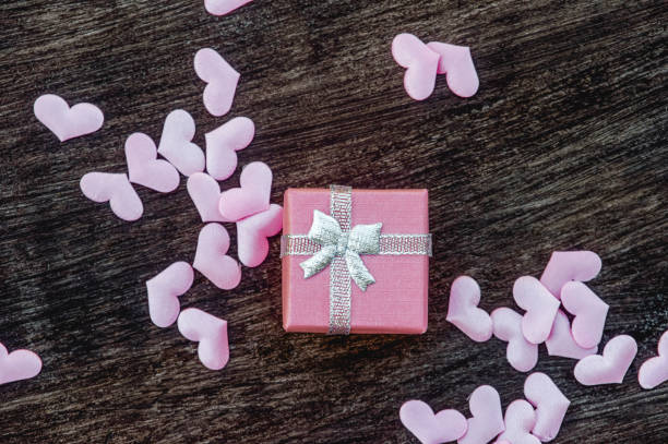 istock Gift box with hearts on a wooden background. Valentine`s day. 1200114925