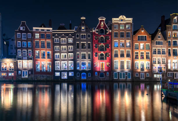 istock Typical Amsterdam houses with reflection in the water 1200115256