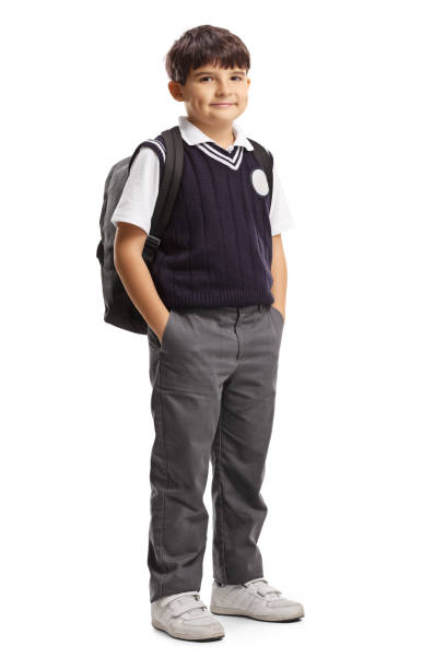 istock Schoolboy in a uniform posing with hands in pockets 1200115278