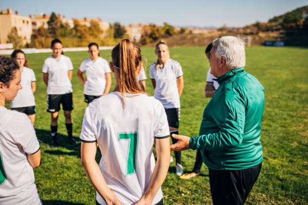 istock Girls soccer team with coach on training 1200116041
