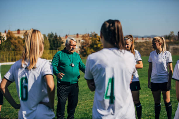 istock Women soccer team with coach on training 1200116086