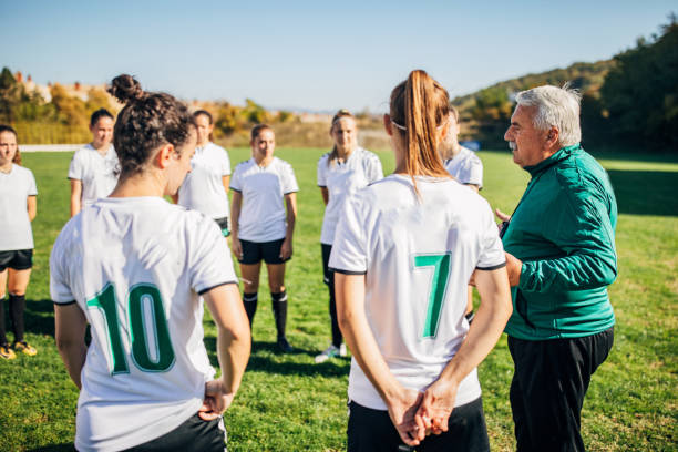 istock Girls soccer team talking to coach on training 1200116135