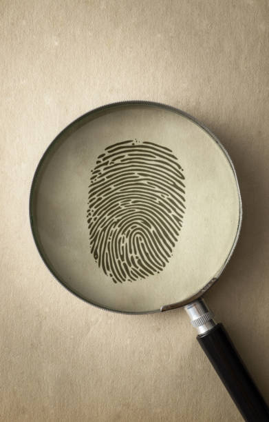 istock Black Fingerprint Under a Magnifying Glass 1200117231