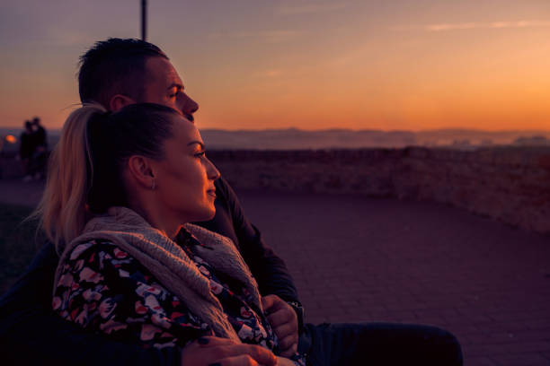 istock Couple watching  at evening the sunset 1200117719