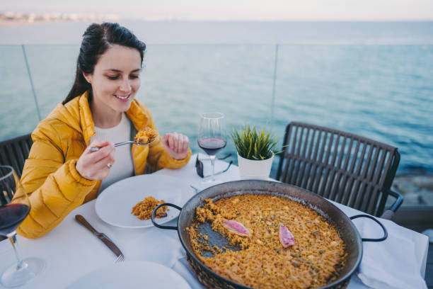 istock Tourist eating Spanish paella at the beach 1200120243