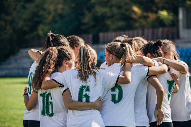 istock Women soccer team celebrating victory 1200120482