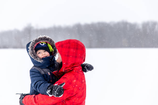 istock Mother and Son Having Fun Outdoors During Snowstorm 1200120548