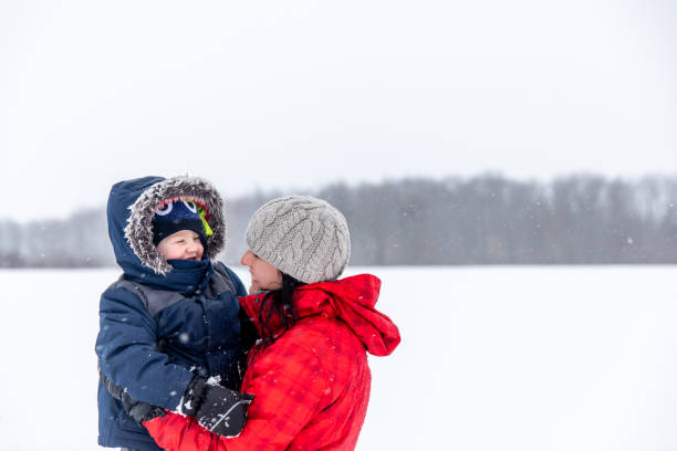 istock Mother and Son Having Fun Outdoors During Snowstorm 1200120586