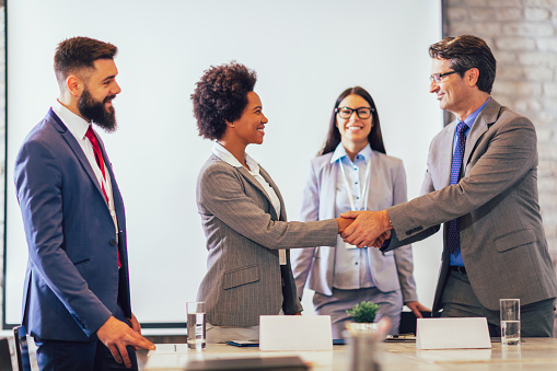 Business people shaking hands in the office. Finishing successful meeting.