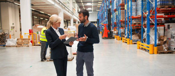 istock Managers in Warehouse discuss about business 1200121580