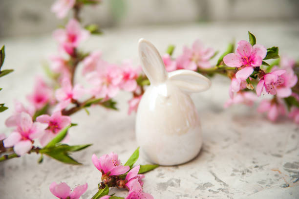 istock Spring photo of a blossoming tree and Easter eggs close-up and copy space. Easter card concept with bunny and eggs. Trending pink shades. 1200121829