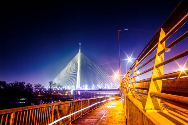 Giant Ada Bridge pylon rising to the sky, illuminated at nighttime