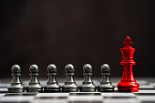 istock Red king chess with others black pawn chess for leader and different thinking.Disrupt concept. 1200123261