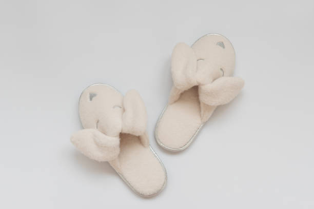 Pink fur slippers in shape of rabbit on white background.Top view. Copy space