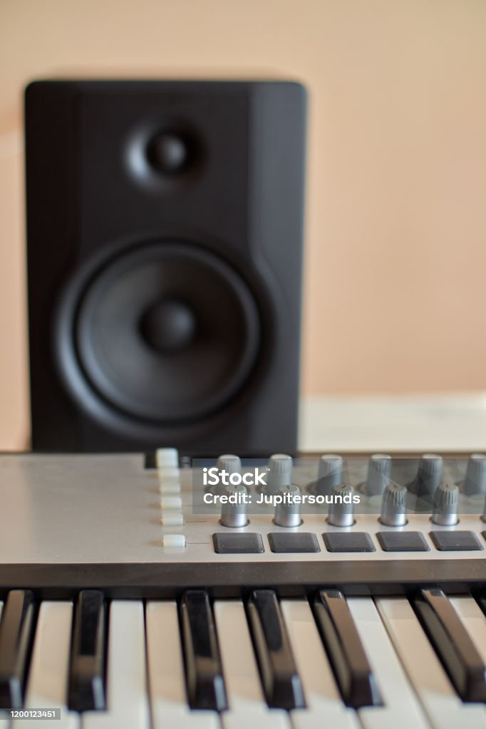 Master keyboard in the foreground and monitor in the background Arts Culture and Entertainment Stock Photo