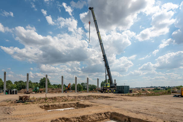 istock on a construction site, concrete columns for a factory building are placed with the help of a large crane 1200123458