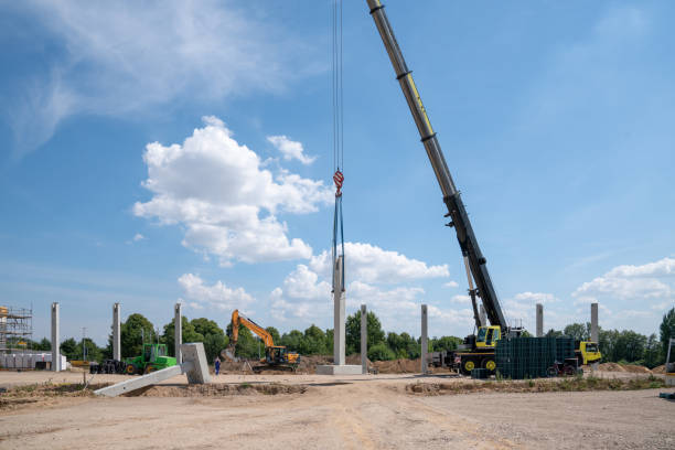istock on a construction site, concrete columns for a factory building are placed with the help of a large crane 1200123477