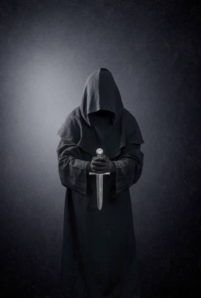 Ghostly figure with medieval dagger in the dark Ghostly figure with medieval dagger in the dark black knight stock pictures, royalty-free photos & images