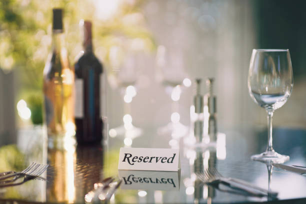 Restaurant reserved table sign with place setting and wine glasses ready for a party