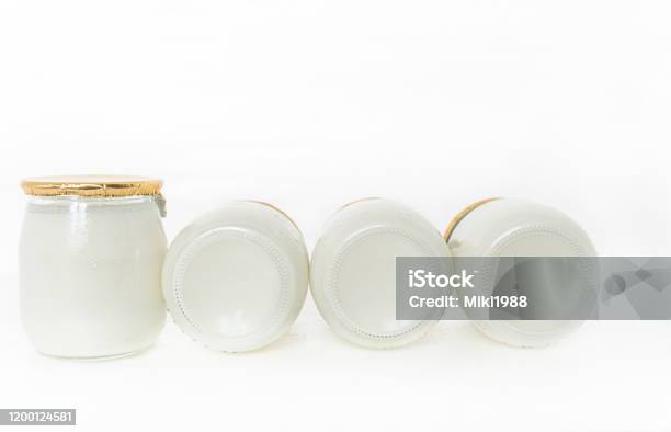 Greek Yogurt In A Glass Jars With Spoons On White Background Stock