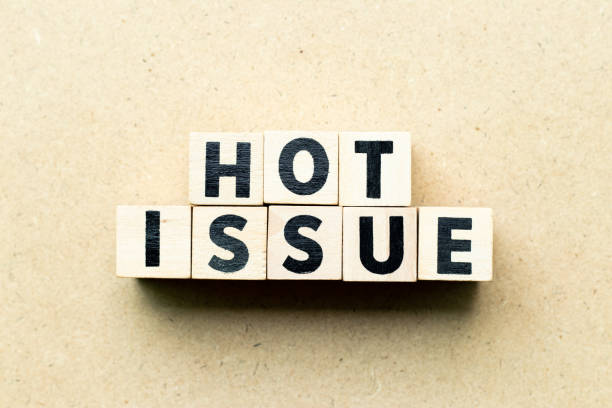 istock Letter block in word hot issue on wood background 1200127508