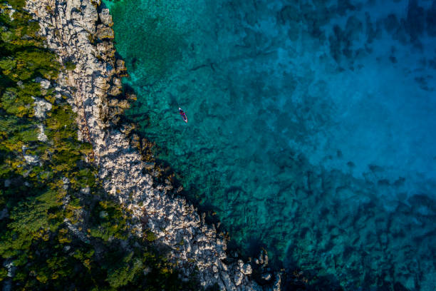 istock Woman kayaking clear turquoise sea 1200128306