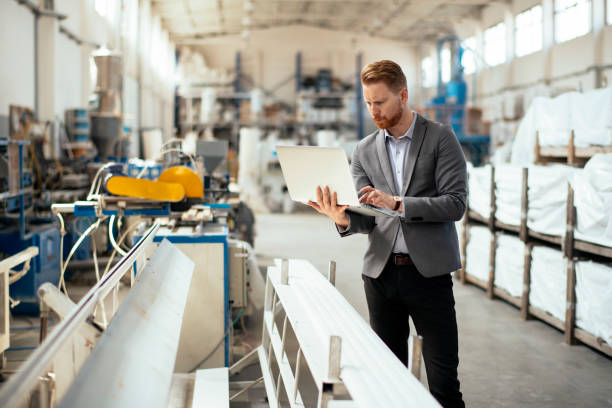 istock Business man checking quality on laptop in factory 1200128376