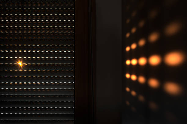 Shutters - blinds with sunlight in the morning. Dark wooden window with blinds. Interior abstract design of living room with window horizontal blinds. Soft focus abstract background