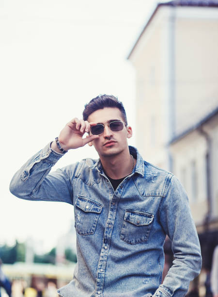 istock Stylish guy standing street 1200130875