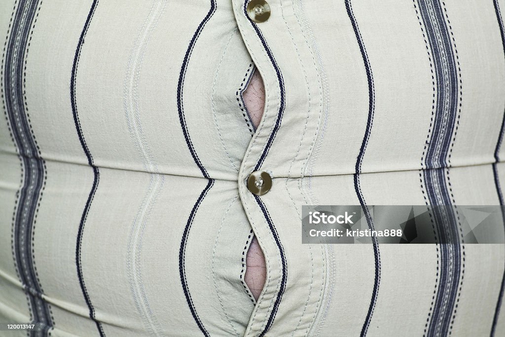 Close-up of shirt that is too tight, depicting weight gain Man with tight s striped shirt Shirt Stock Photo